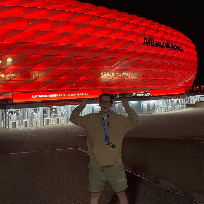 Photograph of White woman with brown hair standing in front of the Allianz stadium