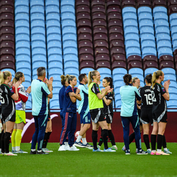 Arsenal players and staff applauding the fans