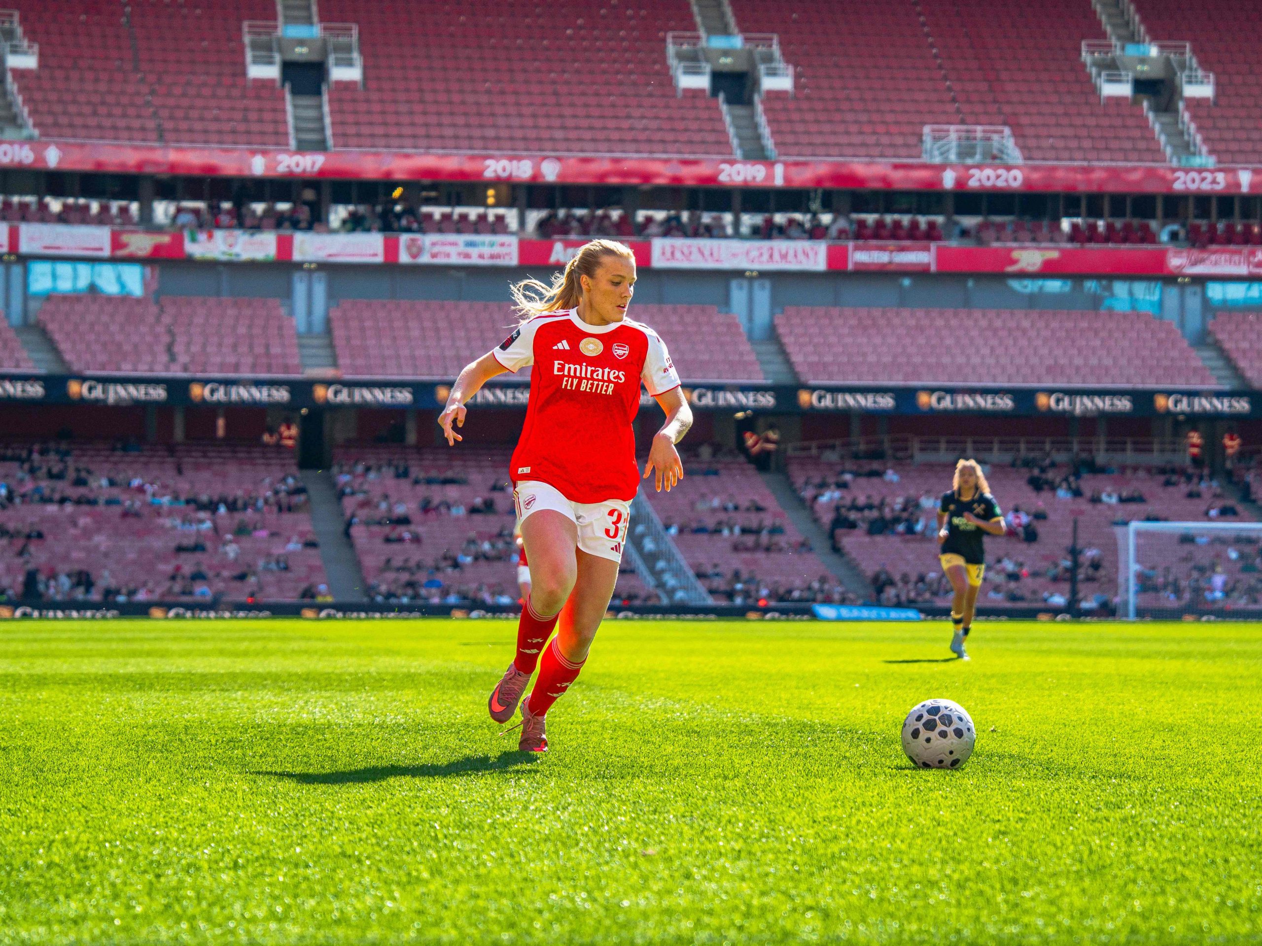Smilla Holmberg in action for Arsenal Women, running towards the ball during a match at Emirates Stadium.