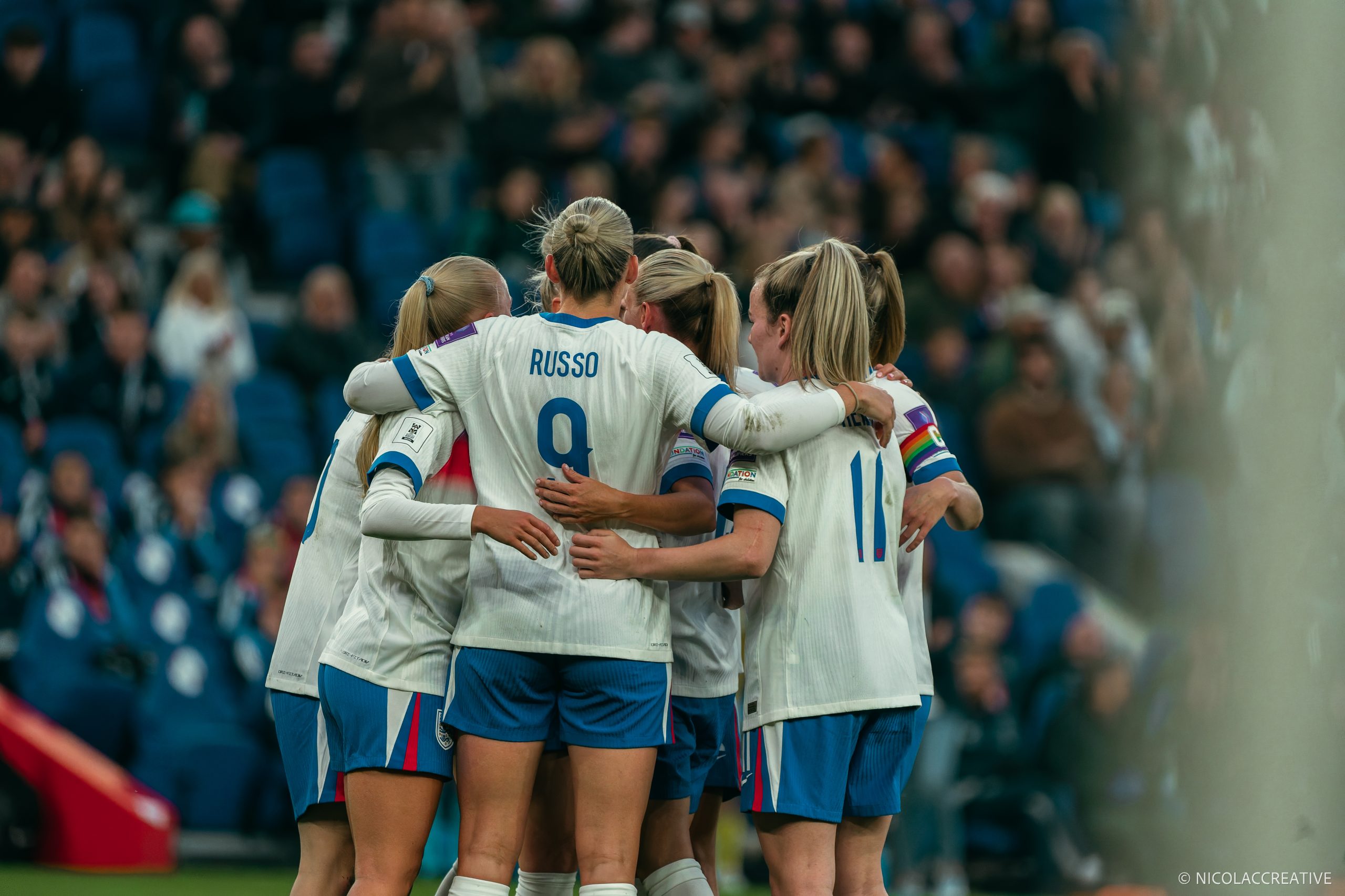Lionesses team celebration in the middle of the Pitch